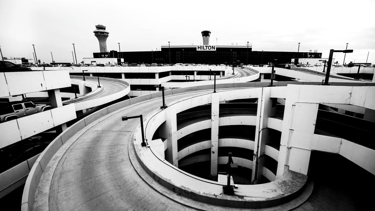Spiralförmige Ein- und Ausfahrtsrampe eines Parkhauses am Flughafen in Schwarz-Weiß